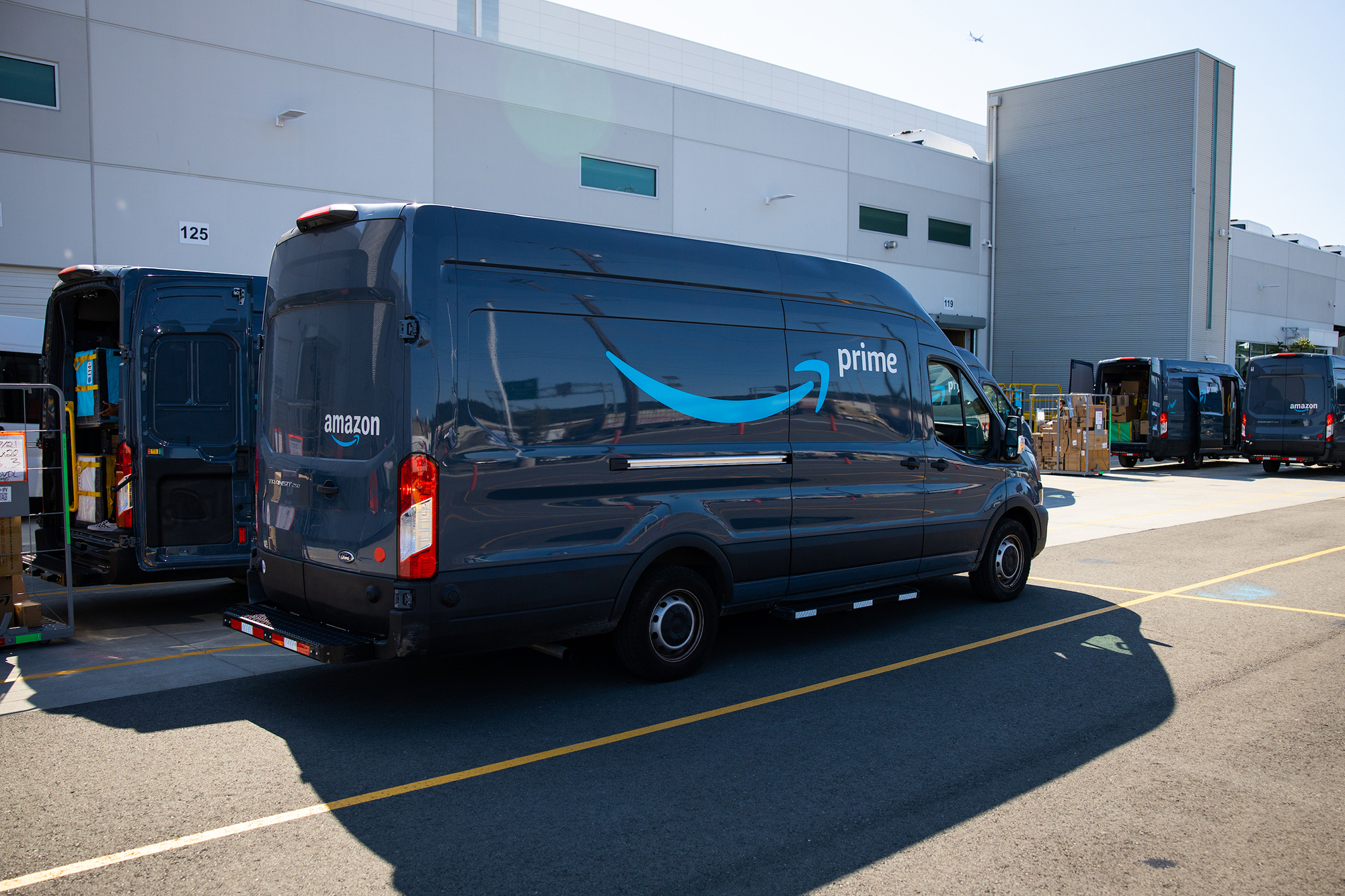 Amazon UK delivery vans at a loading area for deal fulfilment context